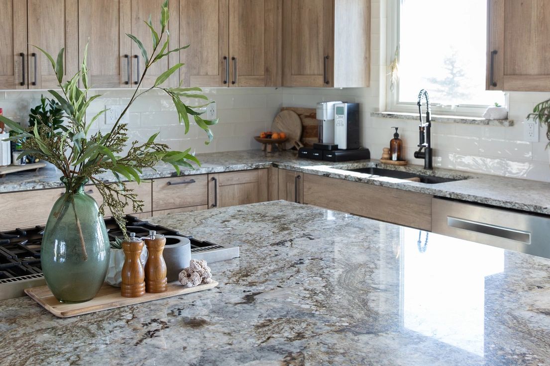 Kitchen inspiration with a patterned stone island and warm wooden cabinetry